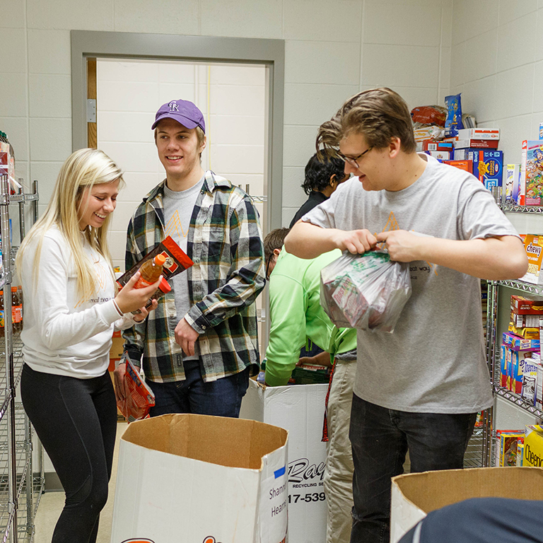 Students stock shelves at Paws' Pantry.